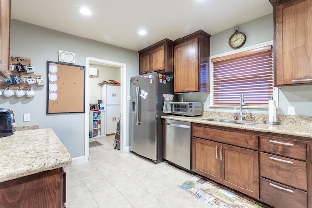 kitchen featuring light tile patterned floors, stainless steel appliances, and sink