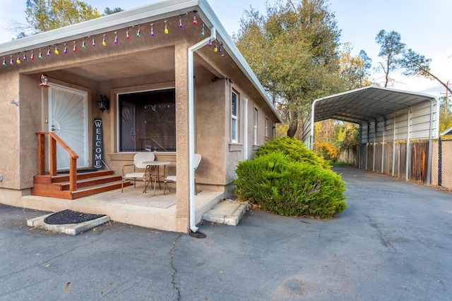 view of side of property featuring a carport