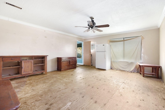 unfurnished bedroom with ceiling fan, white refrigerator, and crown molding