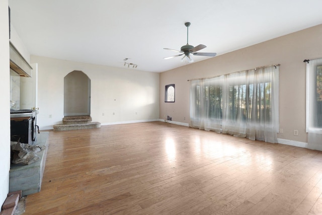 unfurnished living room featuring light hardwood / wood-style floors and ceiling fan