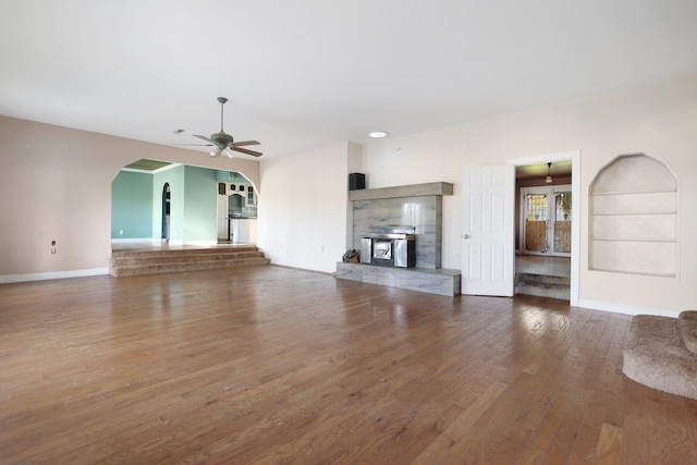 unfurnished living room featuring ceiling fan and wood-type flooring