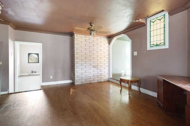 interior space with hardwood / wood-style floors, a textured ceiling, ceiling fan, and ornamental molding