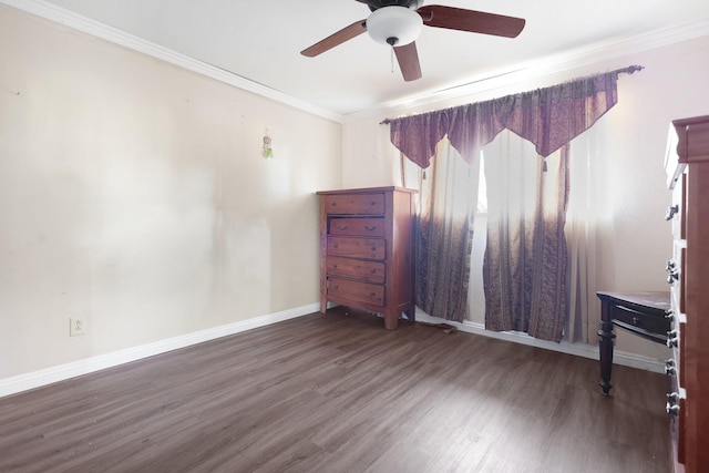 unfurnished room featuring ceiling fan, dark hardwood / wood-style floors, and crown molding