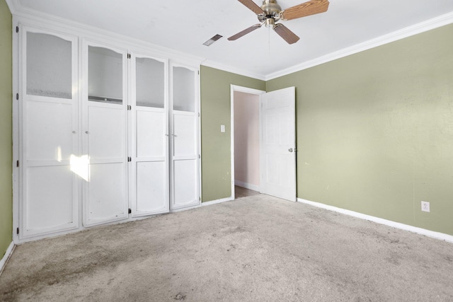 unfurnished bedroom with ceiling fan, ornamental molding, and light carpet