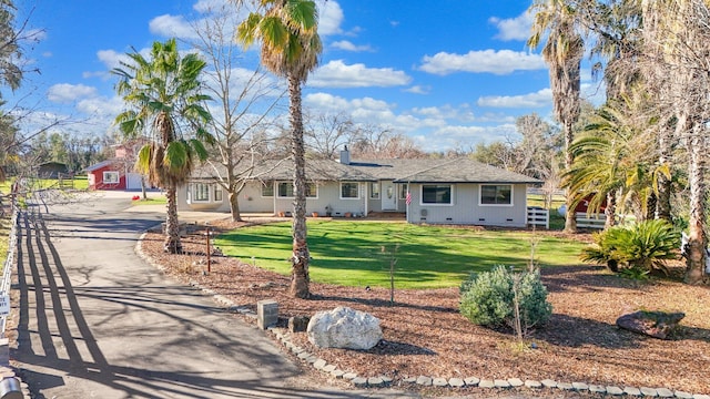 single story home with a front lawn