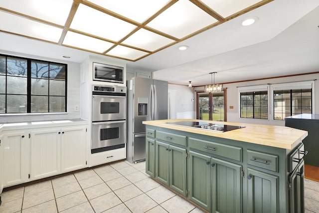 kitchen with a center island, green cabinets, decorative light fixtures, white cabinetry, and stainless steel appliances