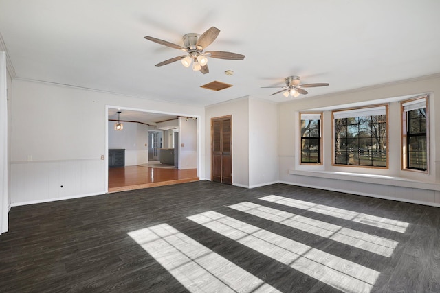 unfurnished living room featuring crown molding, ceiling fan, and dark hardwood / wood-style floors