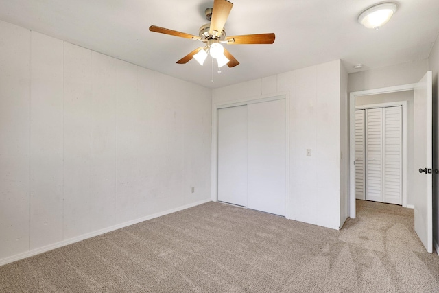 unfurnished bedroom featuring ceiling fan and light carpet