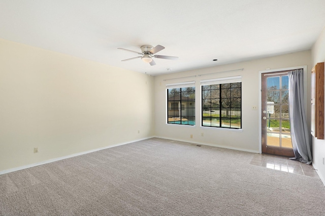 unfurnished room featuring ceiling fan and light carpet