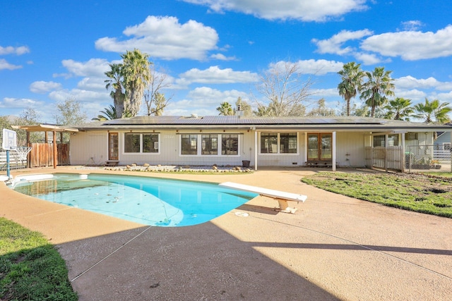 view of pool featuring a diving board and a patio area