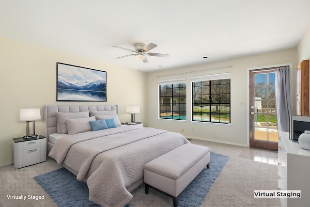 carpeted bedroom featuring access to exterior and ceiling fan