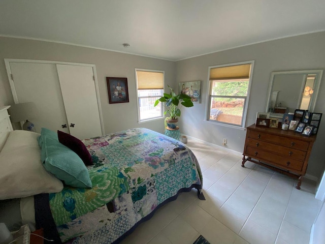 bedroom with crown molding and a closet