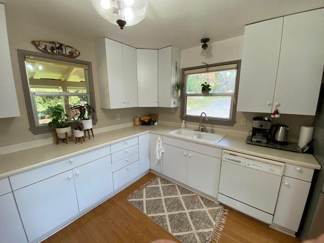 kitchen with light hardwood / wood-style floors, dishwasher, sink, and white cabinets