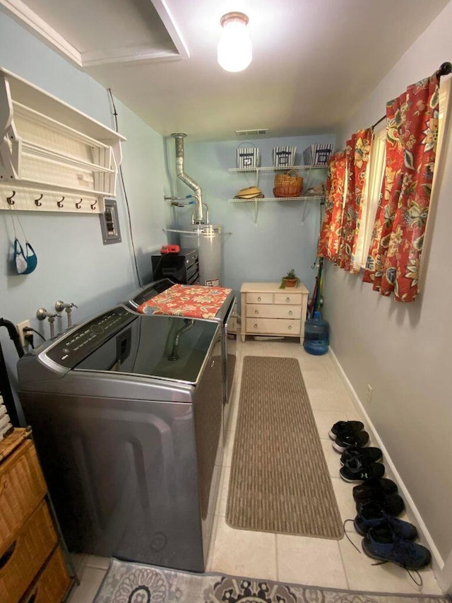 laundry area with independent washer and dryer, tile patterned flooring, and water heater