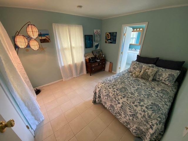 tiled bedroom featuring crown molding and ensuite bath