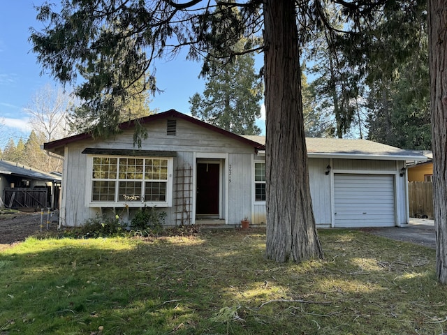 single story home featuring a front yard and a garage