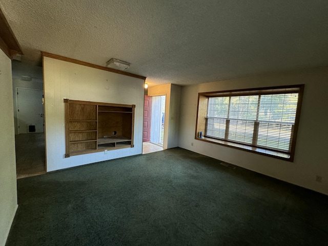 unfurnished living room featuring dark carpet and a textured ceiling