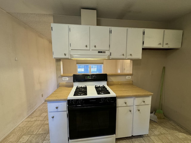 kitchen featuring white gas range and white cabinets