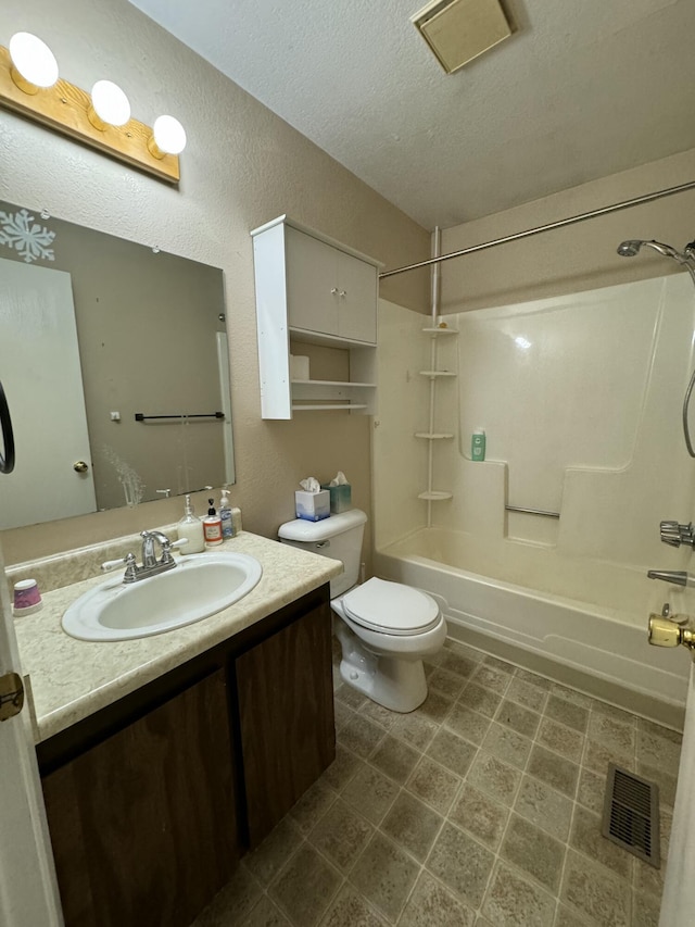 full bathroom with shower / bathing tub combination, vanity, toilet, and a textured ceiling