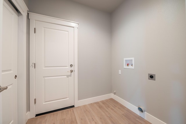 laundry area with washer hookup, light hardwood / wood-style floors, and hookup for an electric dryer