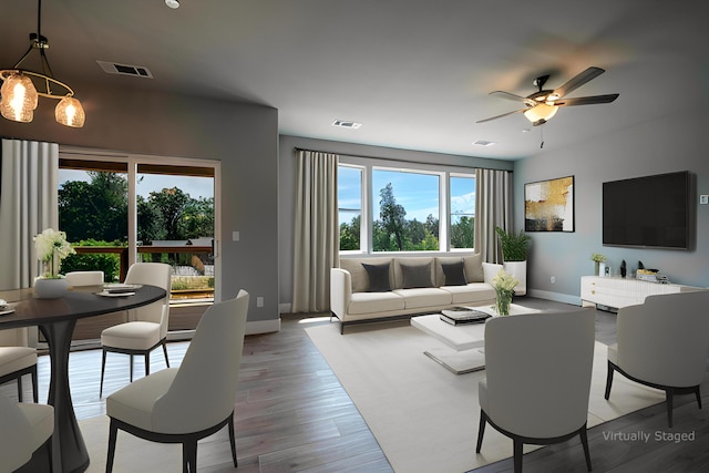 living room with hardwood / wood-style flooring and ceiling fan with notable chandelier