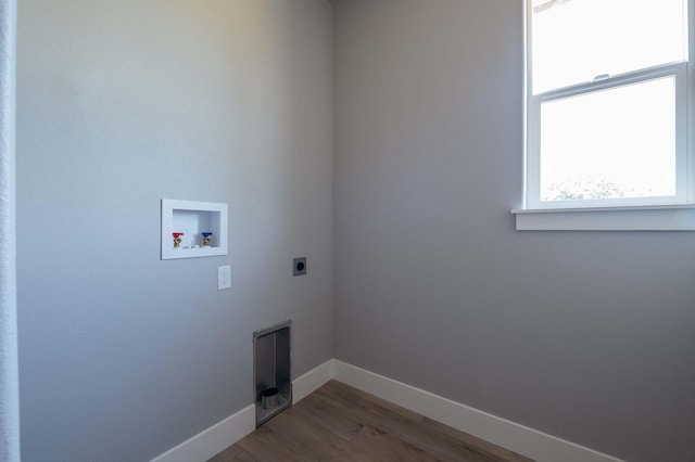 clothes washing area with electric dryer hookup, wood-type flooring, and washer hookup