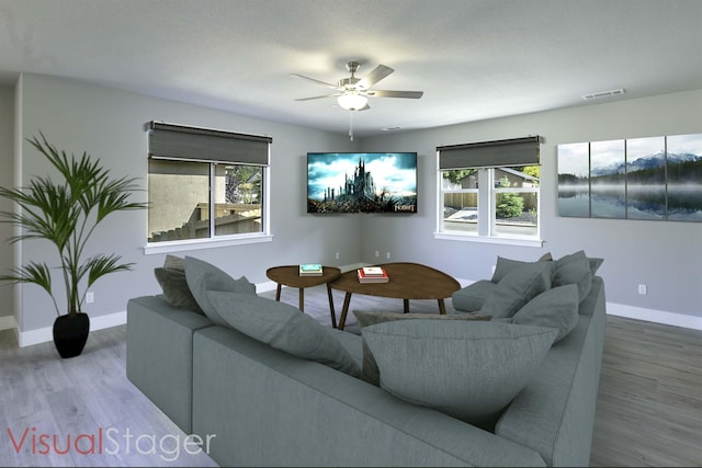 living room with ceiling fan, wood-type flooring, and a textured ceiling