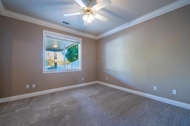 carpeted spare room featuring crown molding and ceiling fan