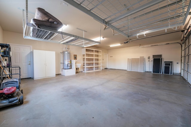 garage featuring sink, a garage door opener, and water heater