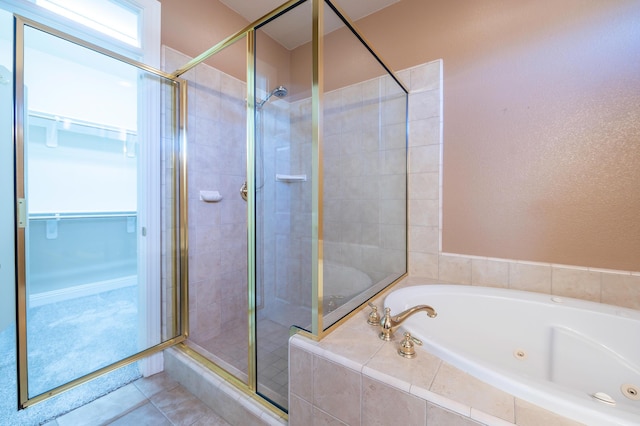 bathroom with tile patterned flooring and separate shower and tub