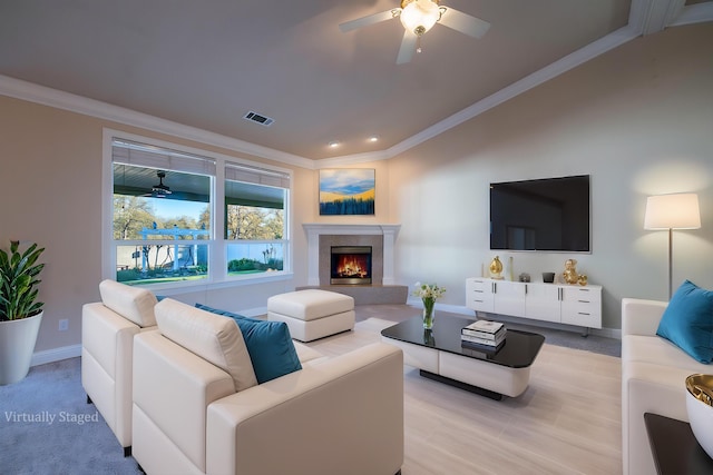 living room featuring crown molding, vaulted ceiling, and ceiling fan