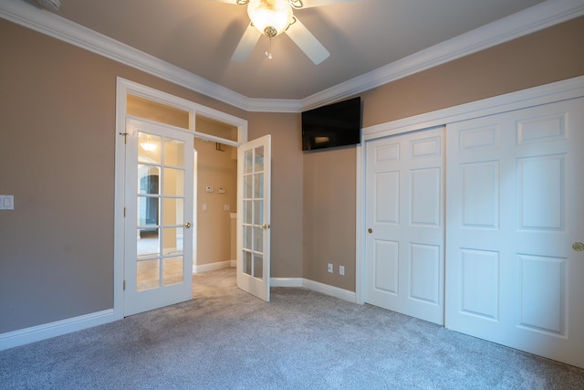 unfurnished bedroom featuring french doors, ceiling fan, carpet, and a closet