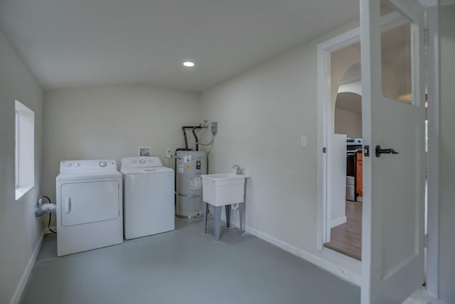 laundry room featuring water heater, washer and clothes dryer, and sink