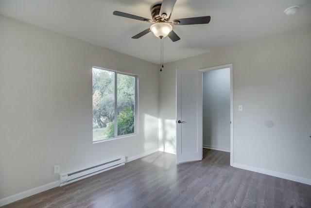 empty room featuring ceiling fan, dark wood-type flooring, and a baseboard radiator