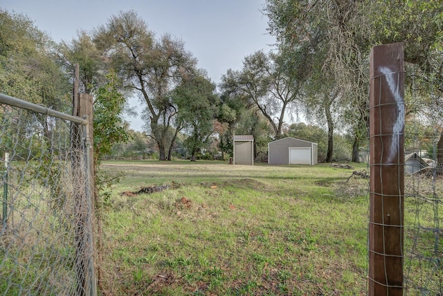 view of yard with a garage and an outdoor structure