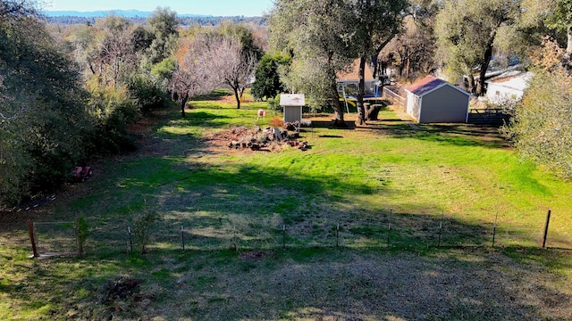 view of yard with a rural view and a storage shed