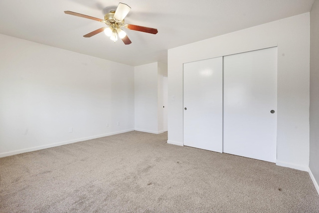 unfurnished bedroom featuring ceiling fan, a closet, and carpet