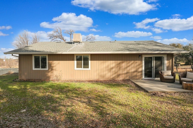 back of house with a yard and a patio