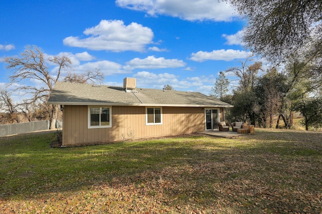 rear view of house featuring a yard and a patio area