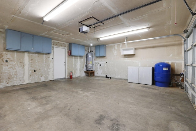 garage featuring strapped water heater and a garage door opener