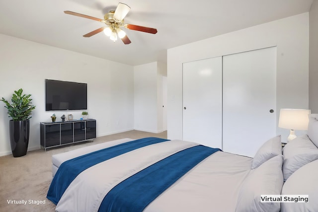 carpeted bedroom with a closet and ceiling fan