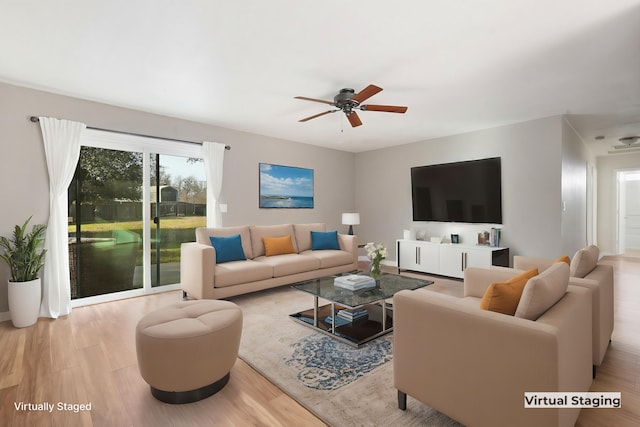 living room featuring ceiling fan and light wood-type flooring