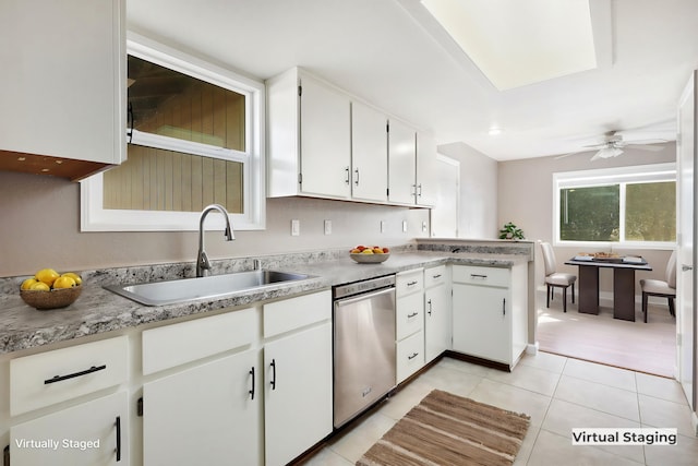 kitchen with stainless steel dishwasher, ceiling fan, sink, light tile patterned floors, and white cabinets