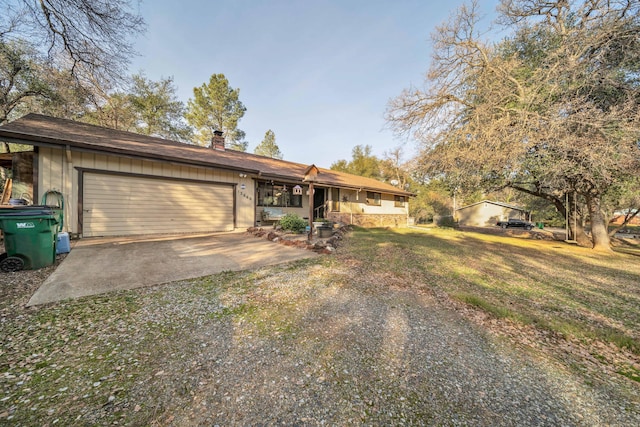 ranch-style house with a garage and a front lawn