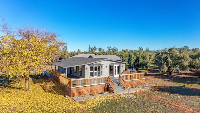 view of front of house with a front yard and a deck