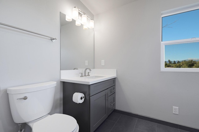 bathroom featuring tile patterned flooring, vanity, and toilet