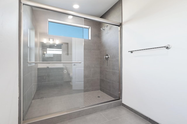 bathroom featuring tile patterned flooring and an enclosed shower