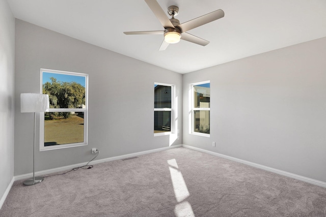 carpeted spare room featuring ceiling fan