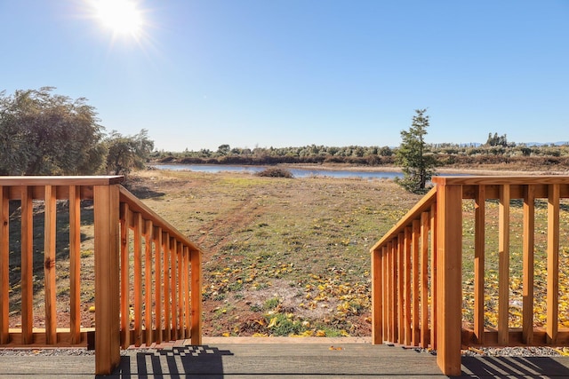 wooden deck featuring a water view