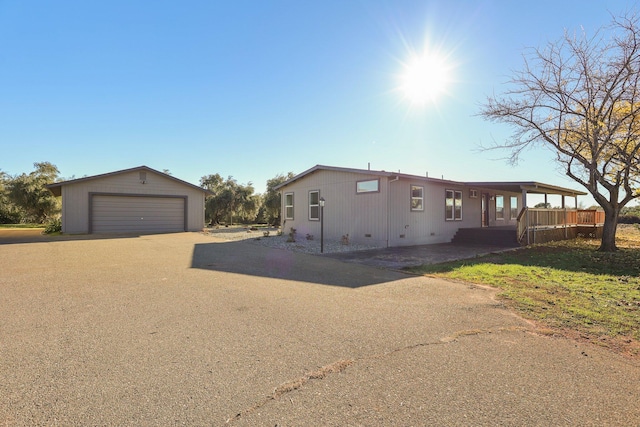 view of front of property with a garage and an outdoor structure